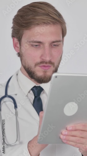 Young Doctor using Digital Tablet on White Background, Vertical Video