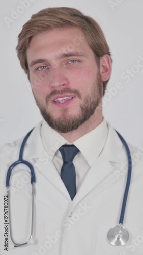 Young Doctor Talking on Online Video Call on White Background, Vertical Video