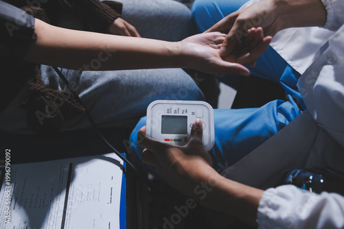 Fotografija The doctor measures blood pressure to the patient