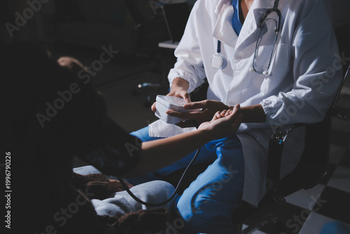 Fotografija The doctor measures blood pressure to the patient