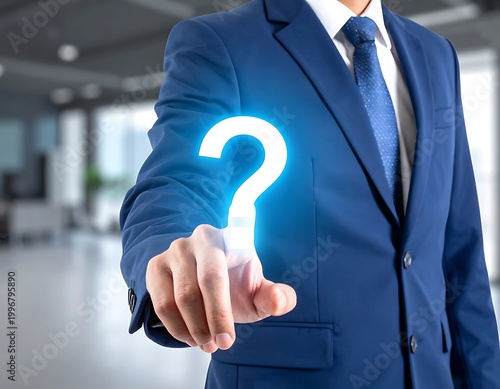 Businessman touching glowing question mark.