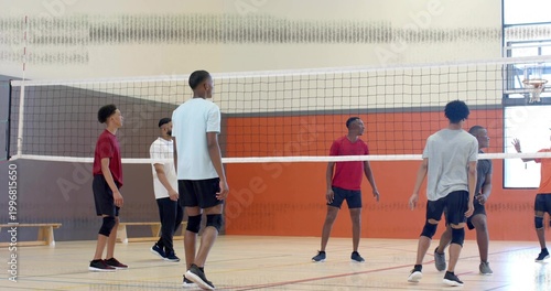 Fotografía Blocking seven male volleyball players wearing athletic shorts and knee pads at