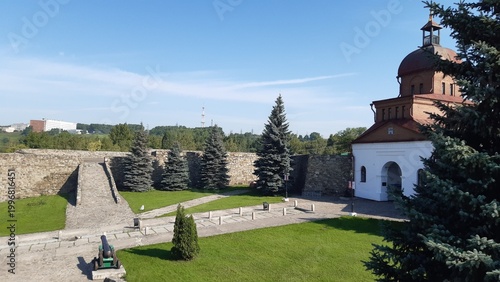 Photos Historic site features an old stone wall, trees, and a building with a dome unde