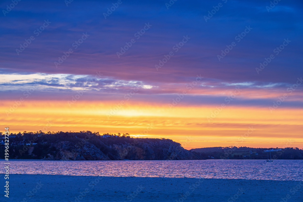 Fototapeta premium Sunrise at the rocky coastline in the french Bretagne