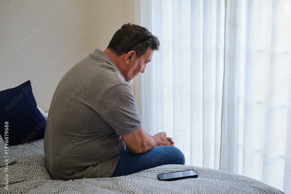 Ταπετσαρία view from behind of Mature man sitting pensively in bedroom feeling lonely