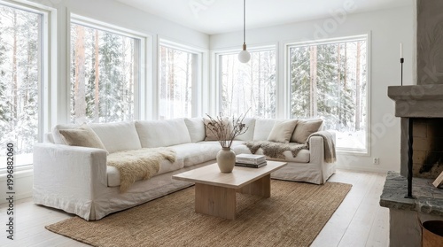 Bright modern Nordic living room with a white sofa and snowy forest view
