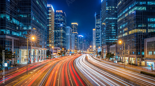 Tableau sur toile Lively city street at night captured with long exposure, showcasing dynamic car light trails between modern skyscrapers