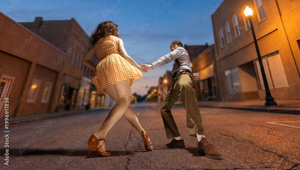 Obraz premium Couple dancing lindy hop on empty street at dusk under warm street lights with low angle view and motion. Concept of romance, vintage lifestyle, travel and nightlife entertainment.