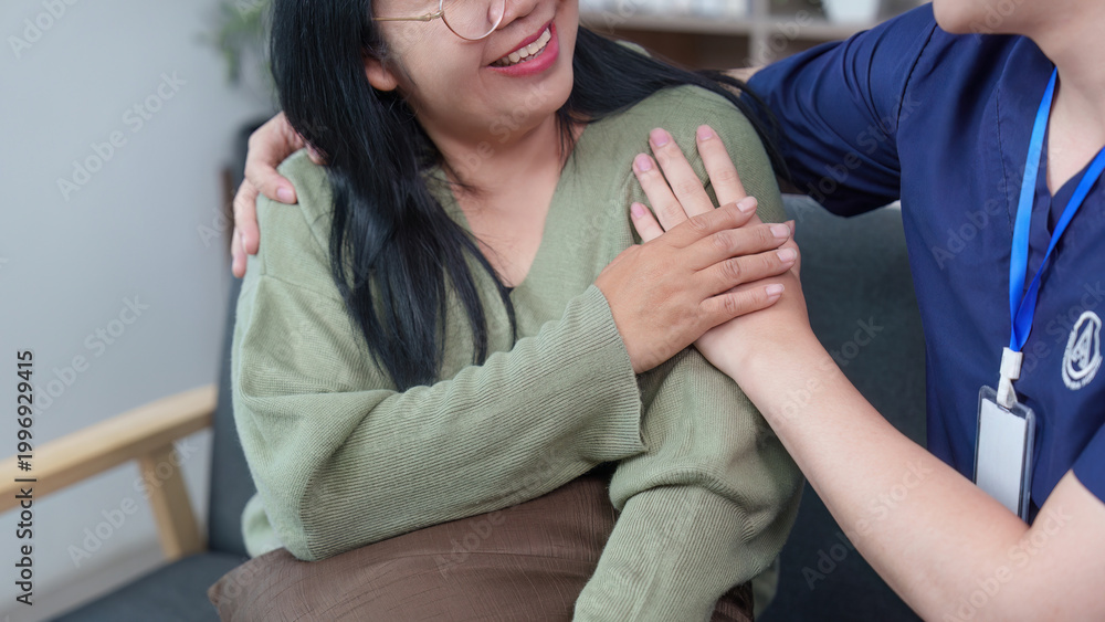Fototapeta premium Asian healthcare professional comforting woman patient with empathy
