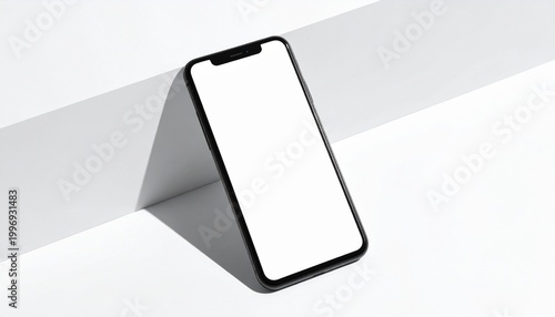 Minimalist mobile phone display with a clean white screen against a contrasting shadow on a white surface