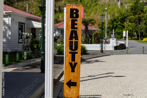 Beauty Arrow Sign Beside Sunny Village Street