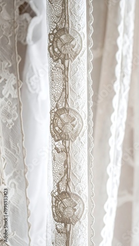 Close-up of delicate white fabric, possibly a curtain or drapery, with intricate floral lace trim and soft lighting