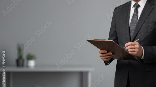 Professional Businessman Writing on Clipboard in Modern Minimalist Office Setting