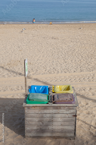 Four dumpsters wooden covered at beach