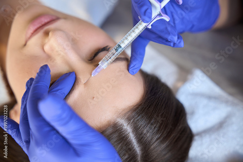 Quadro su tela Caucasian woman receiving injection at beauty clinic