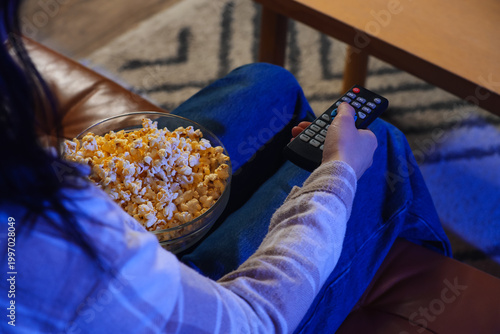 Woman with tasty popcorn wa...