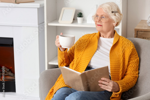 Senior woman with cup of te...