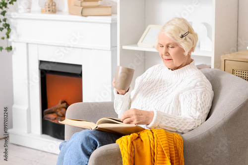 Senior woman with cup of te...