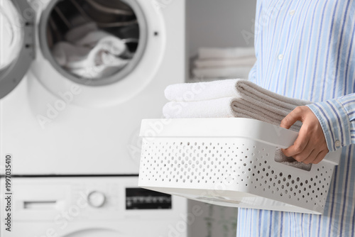 Woman with basket of towels...