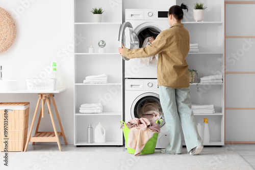 Woman putting towel into wa...