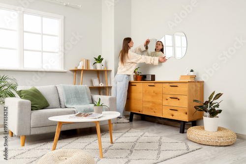 Young woman hanging stylish...