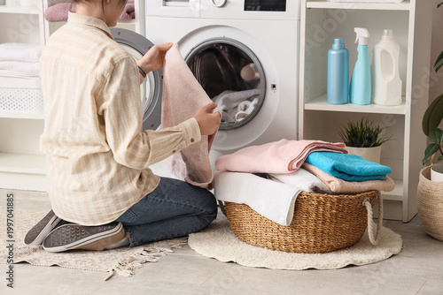 Woman taking towel from was...
