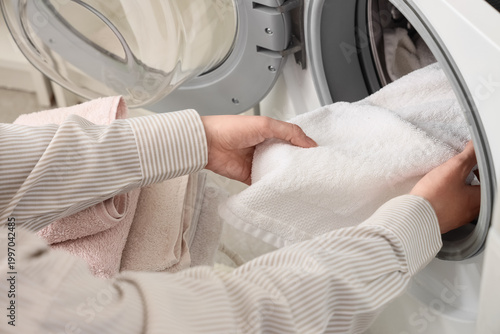 Female hands putting towel ...