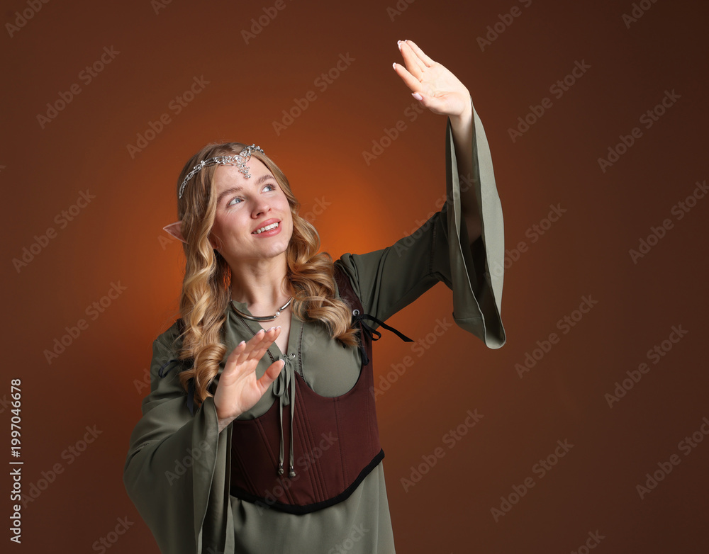 Fototapeta premium Beautiful elf girl on brown gradient background, space for text