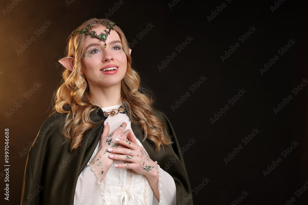 Fototapeta premium Beautiful elf girl on black background with smoke, space for text