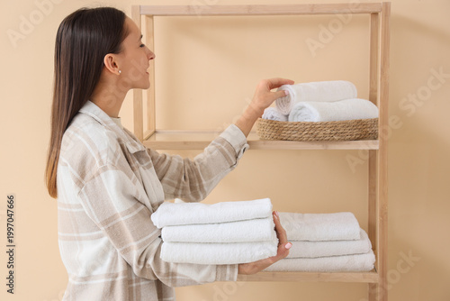 Young woman taking clean to...