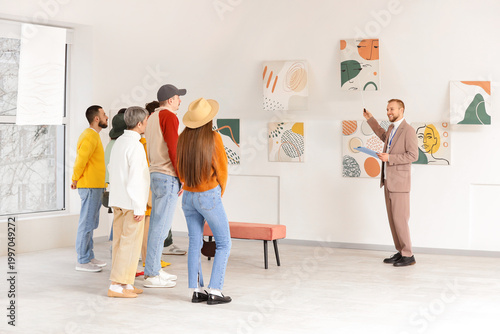 Male guide showing painting...