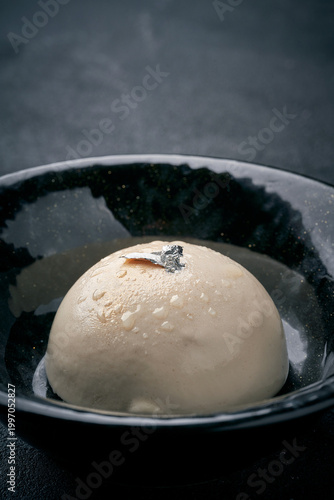 Canvastavla Elegant panna cotta or mousse dessert decorated with silver leaf in a black bowl