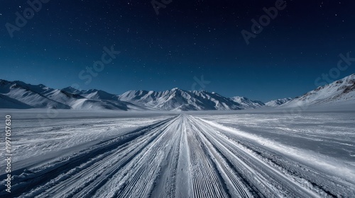 Vast Snowy Mountain Landscape Under a Starry Night Sky With Tire Tracks Leading Into the Distance Serene Winter Wilderness Outdoor Adventure Vastness