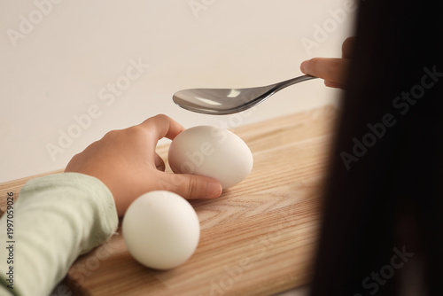 Little girl with boiled egg...