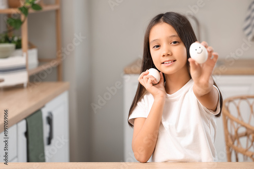 Cute Asian girl with boiled...