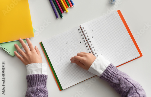 Child erasing drawing in no...