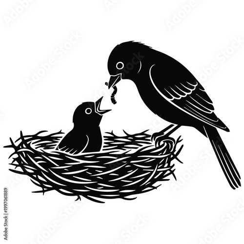Mother bird silhouette feeding a worm to her baby chick in nest