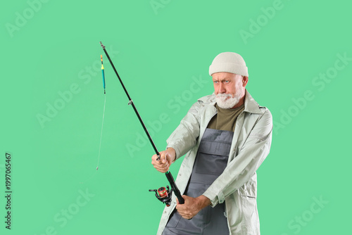 Senior man pulling fishing ...