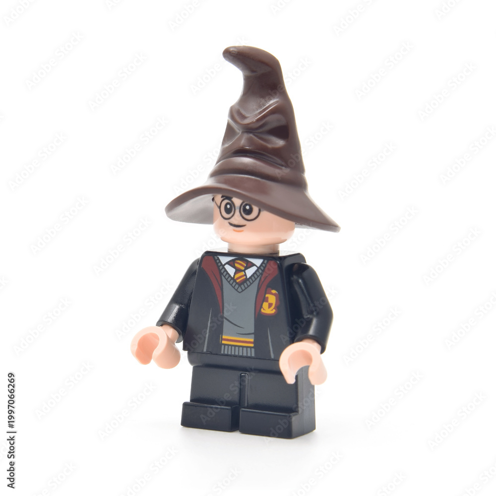 Obraz premium Lego minifigure of Harry Potter and speaking hat isolated on white. Editorial illustrative image of famous fantasy person.