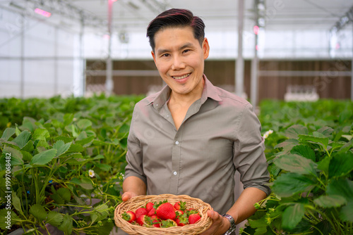 The Asian man travel at strawberry green house.