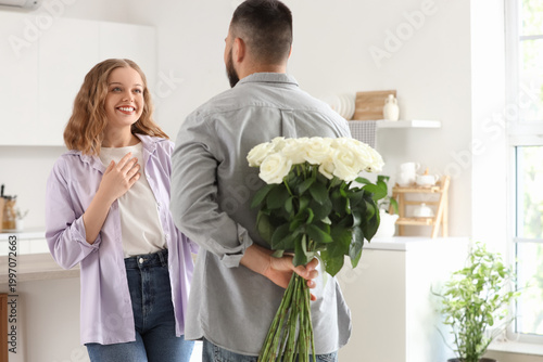Young man with white roses ...