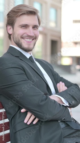 Young Businessman Smiling at Camera while Sitting on Bench, Vertical Video