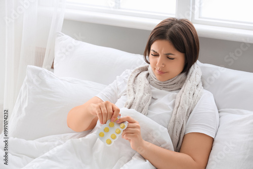 Ill young woman with throat...