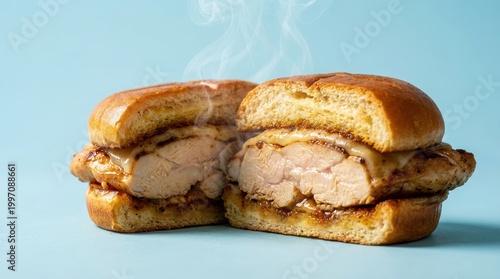 Juicy Grilled Chicken Sandwich with Melted Cheese on Toasted Bread Against a Blue Background
