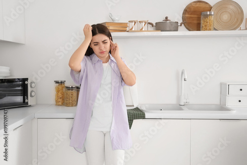 Young woman feeling pain in...