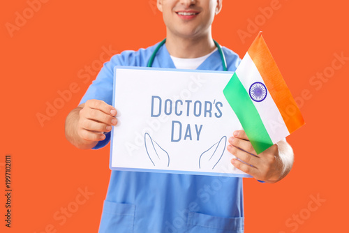 Male nurse holding clipboar...