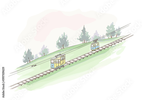 Two cable cars ascend a grassy hill with trees in the background