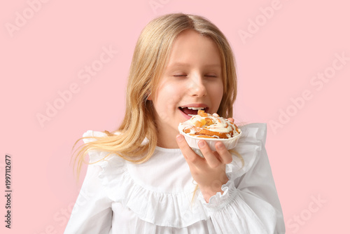 Cute little girl eating tas...