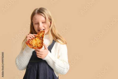 Cute little girl eating tas...
