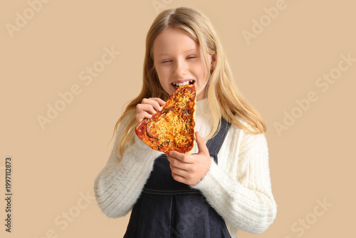 Cute little girl eating tas...